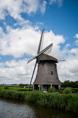 Dutch windmill with cloudy sky in the summer