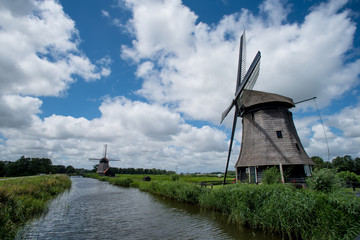 Dutch windmill with cloudy sky in the summer