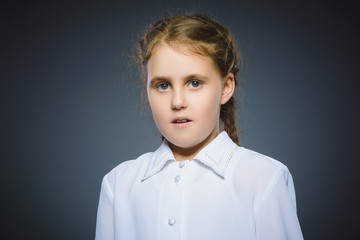 Closeup Portrait of little girl going surprise on gray background