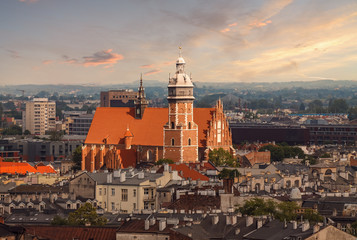 Obraz premium Roofs and the church in sunset light. Krakow