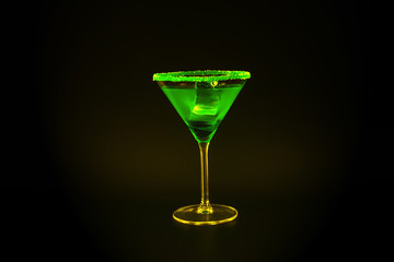 Colorful drink in a cocktail glass, with ice cubes, summer drink
