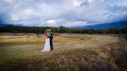 Beautiful bride and her groom on their wedding day looking happy and in love at the start of their marriage