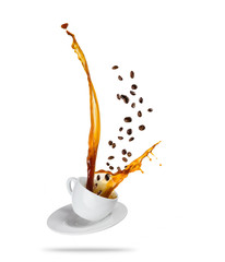 Porcelaine white cup with splashing coffee liquid with coffee beans, isolated on white background.