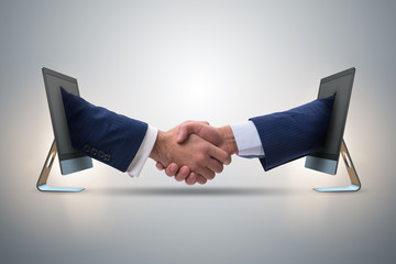 Two hands from screen in handshake concept