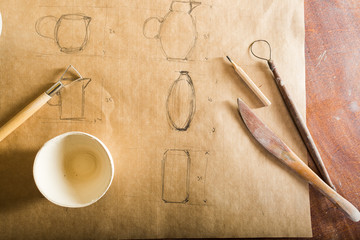 pottery, artisan tools, ceramics art concept - closeup on pencil drawing of earthenware, design and...