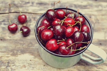 Fresh organic berry fruits, wooden background, sweet cherries