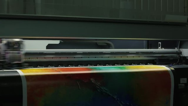Printing head creates colorful image on paper in machine
