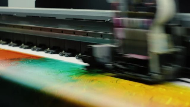 Printing head creates colorful image on paper in machine