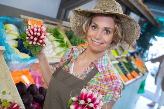happy fruit assistant working at supermarkert