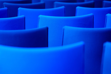 Blue chairs in the conference hall. Nobody. Back view