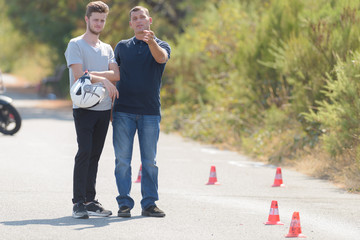 driving instructor explains man the exercise in motordrome