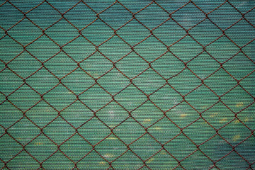 Rusty lattice fence. Old grid. Green texture from striped fabric. Double opaque protection. Old...