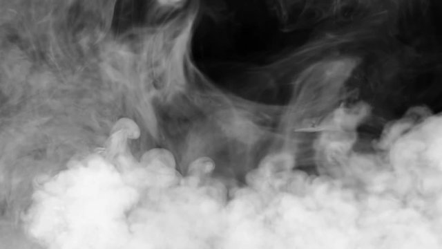 White smoke swirls against a black background