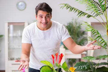 Young man in gardening concept at home