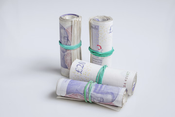 Warsaw, Poland - July 1, 2017: British currency. Four rolls of twenty pound notes held by rubber band