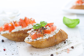 Bruschetta with cream cheese, tomatoes and basil