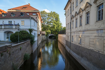 Fototapeta na wymiar Old buildings, bridge and water canal on the Kampa Island in Prague, Czech Republic.