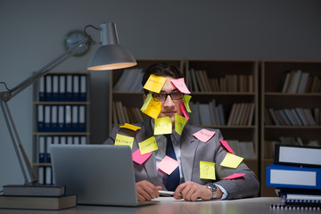 Businessman staying late to sort out priorities