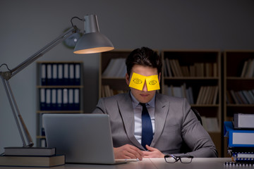 Businessman staying late to sort out priorities