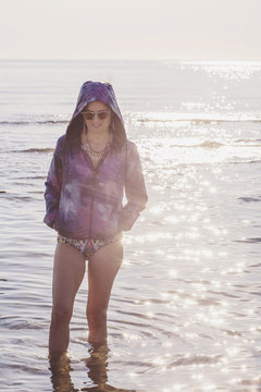 Young woman walking by the sea shore