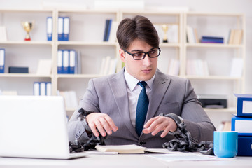 Businessman tied with chains to his work