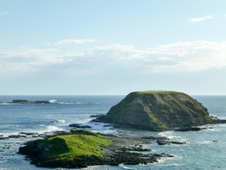 Fototapeta na wymiar Small island or rock formation and an endless ocean