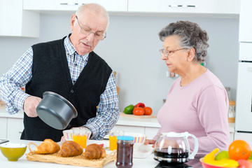 old couple preparing breakfast