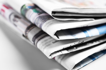 Heap of old folded newspapers, selective focus  