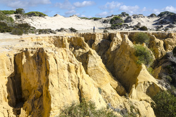 woman making photos on the cliff of the asperillo