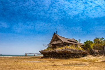 Low tide. Hut on the cliff. Hut on the beach.