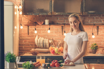 Young woman cooking healthy fresh meal at home