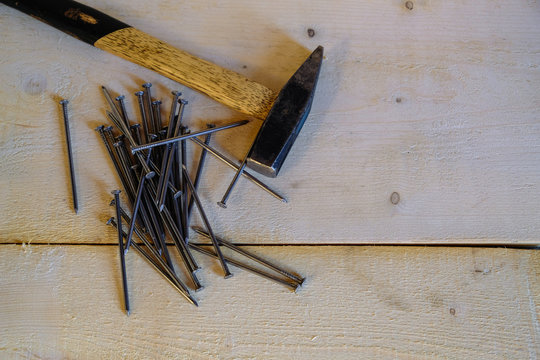Hammer and nails on a wooden board
