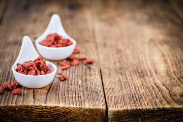 Goji Berries (selective focus) on vintage wooden background