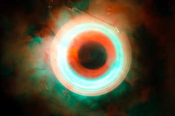 Concept of speed - Trail of fire and smoke - Vinyl record. Burning vinyl disk. Turntable vinyl record player. Retro audio equipment for disc jockey. Sound technology. Close up