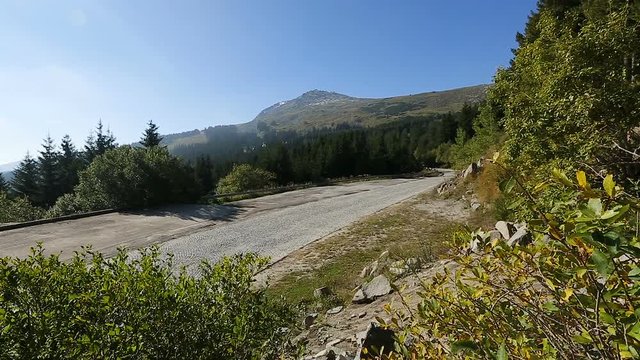 Empty road running in mountains, mountain top covered in rocks, nature, sequence