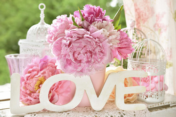 love decoration with wooden letters and peony flowers with color effect