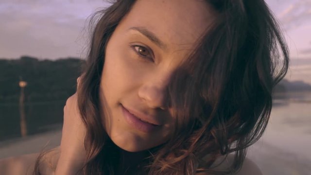 Closeup Of Model's Face, She Laughs, Peeks Out From Behind Hair (Slow Motion)