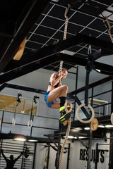 Girl is exercising on a rope