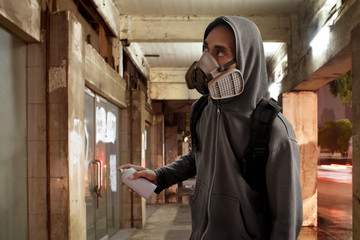 Graffiti artist wearing respirator mask