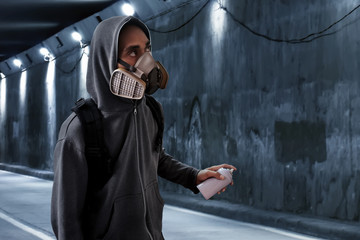 Graffiti artist wearing respirator mask