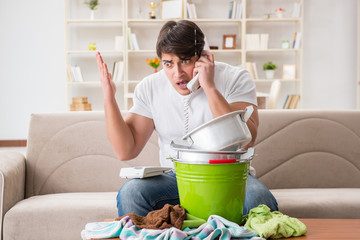 Man at home dealing with neighbor flood leak