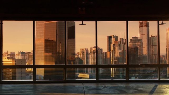 view modern urban architecture in dusk,sun pass through window.sunset