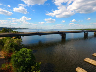 Fototapeta na wymiar Aerial view. Bridge and river in the city Dnepr, Ukraine.