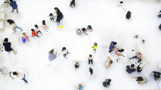 Group Of People Play And Run On The White Bubble Playground On The Top Aerial View.