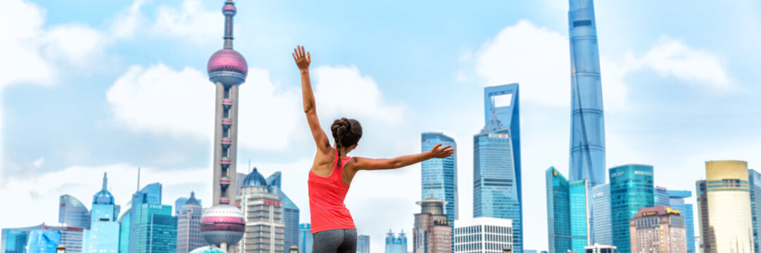 City success winner jumping of joy woman on urban background banner, panorama landscape. Happy businesswoman jumping of joy on achievement career goal challenge.