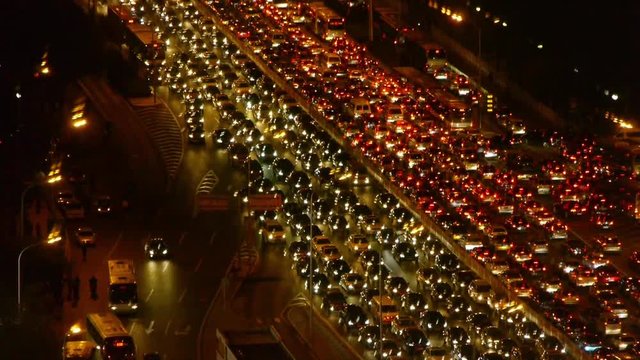 cars jam troop on busy overpass,night traffic pollution in Beijing.