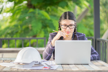 architect woman working with laptop and blueprints,engineer inspection in workplace for architectural plan,sketching a engineering construction project ,selective focus,Business concept vintage color