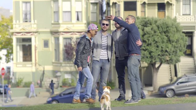 Two Gay Couples Pose For Selfies In Front Of Painted Ladies, In San Francisco, Dog Watches Them 