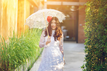 Beautiful Asian bride japanese in vintage style with umbrella in the morning light,wedding ceremony concept