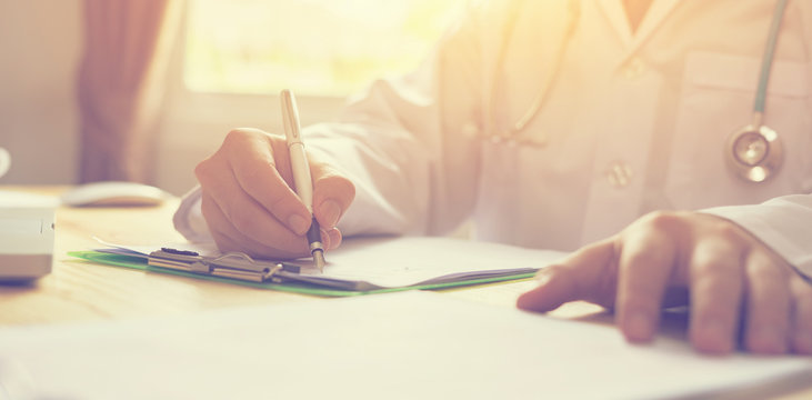 male doctor,surgeon,nurse,pharmacy with stethoscope on hospital holding clipboard,writing a prescription,Medical Exam,Healthcare and medical concept,test results,vintage color,selective focus